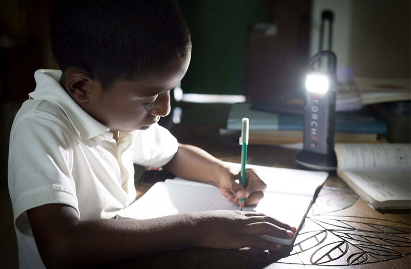 dominican boy reading with lantern xtorch