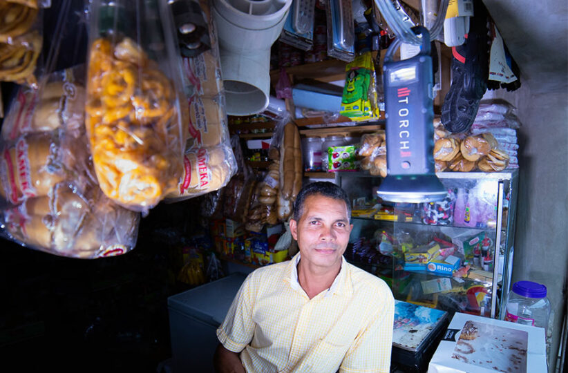 Dominican store owner using solar lantern